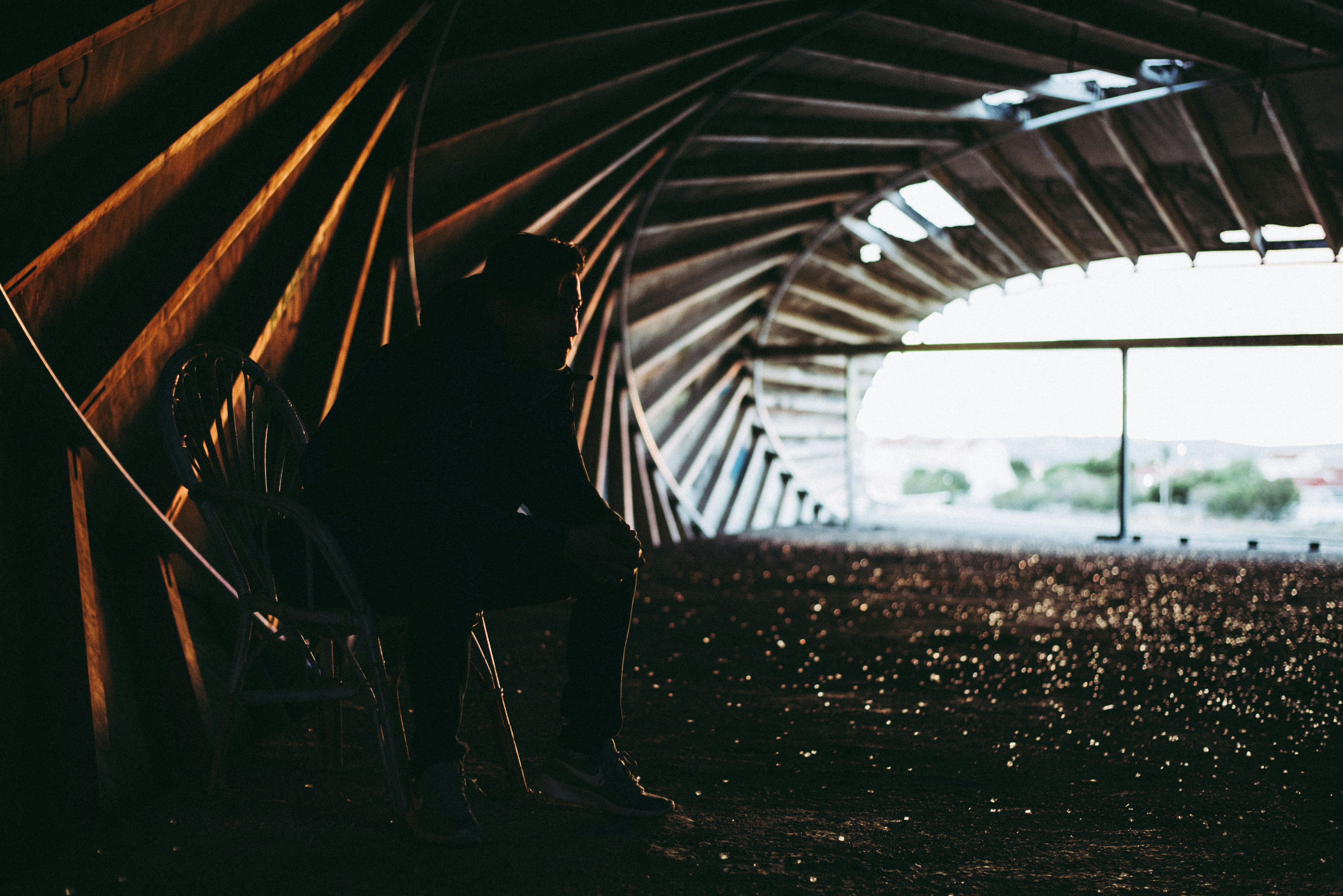 silhouette of person walking on tunnel during daytime